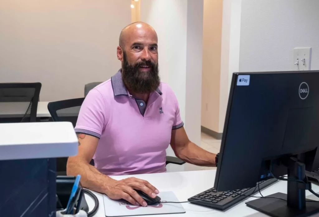 Davis Dental team member smiling at the front desk computer