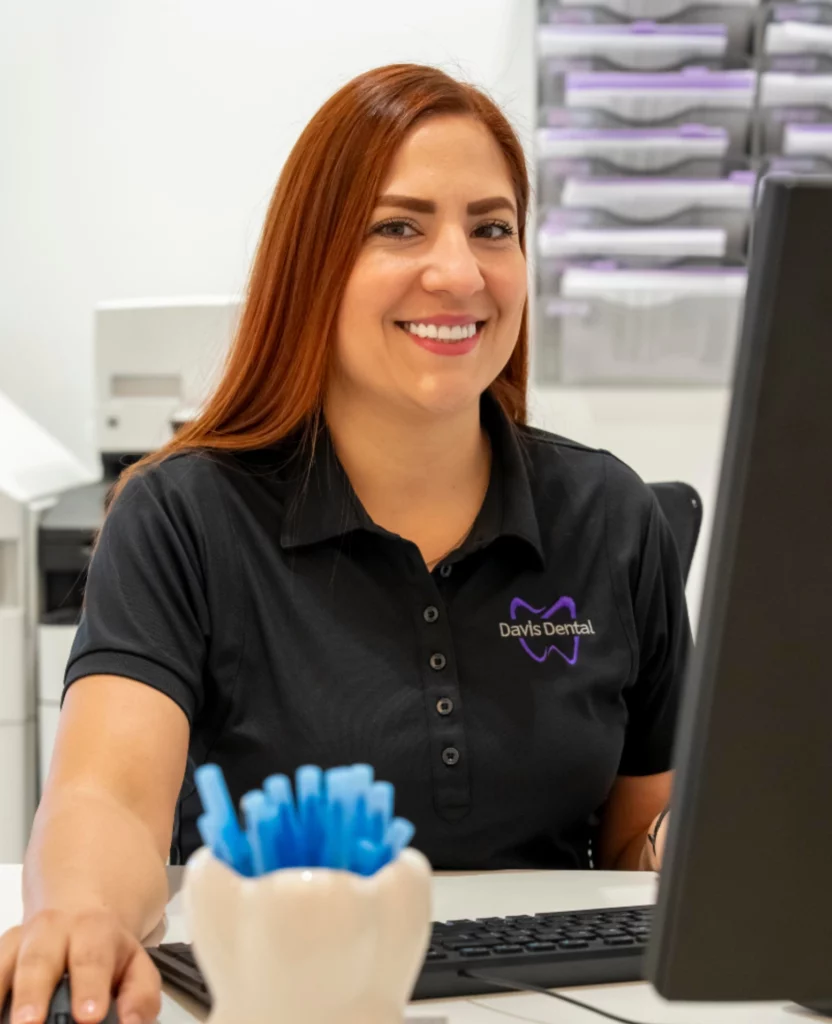 Davis Dental team member smiling at the front desk