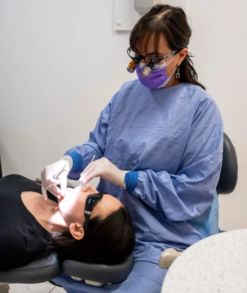 Davis Dental team member treating a patient in the dental chair