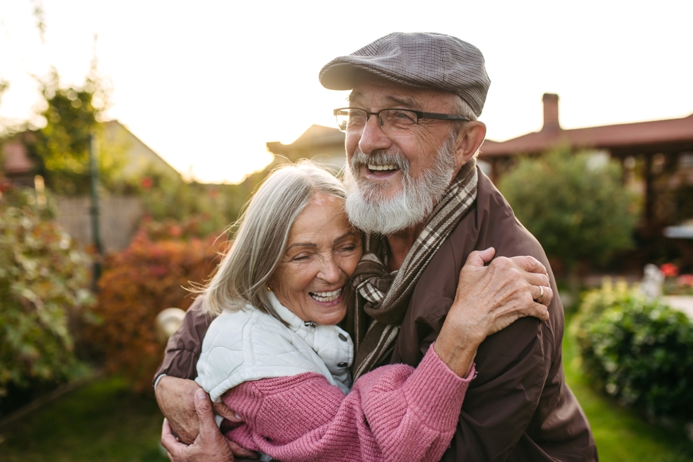 Smiling older couple embracing outdoors