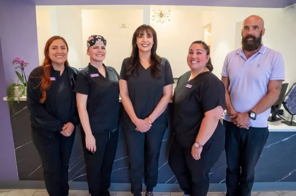 The Davis Dental team standing together in the office
