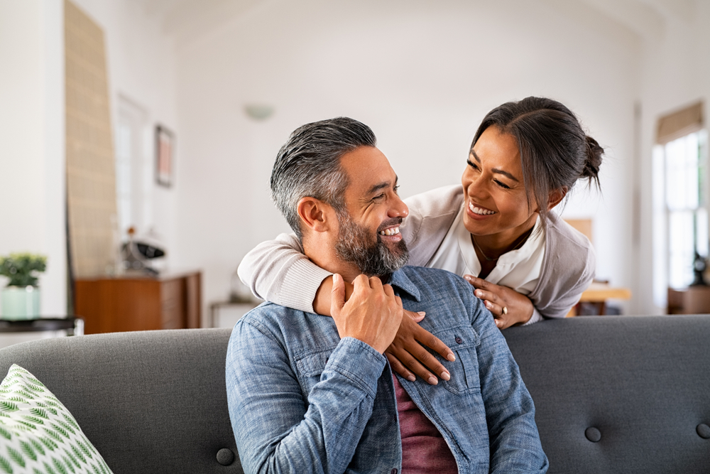 Smiling couple relaxing together on a sofa