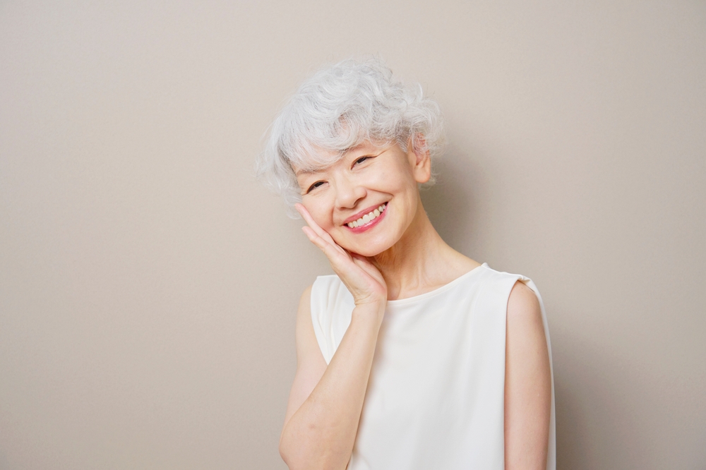 Smiling older woman resting her hand on her cheek